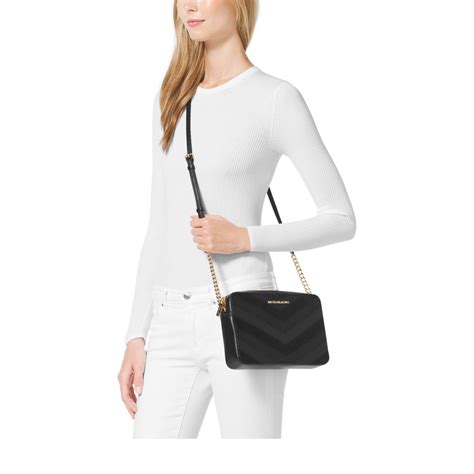 michael kors jet set flat crossbody shoulder bag in black|Michael Kors bag with airplanes.